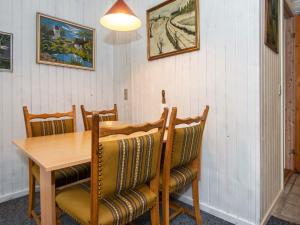 a dining room with a wooden table and chairs at 4 person holiday home in Hemmet in Hemmet