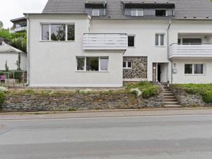 a white house on the side of a street at Beautiful Holiday Home in Winterberg near Ski Slopes in Winterberg