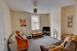a living room with a couch and a table at Pomfret House, in Burnley Central, Ideal for Contractors with Free Parking and Wifi in Burnley