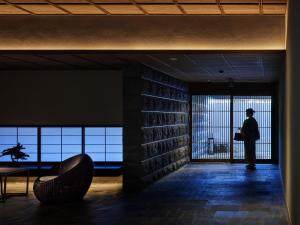a person standing in a room with a window at Onsen Ryokan Yuen Bettei Tokyo Daita in Tokyo
