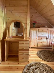 a room with a desk in a wooden house at Willa Pod Strzechą in Wiartel Mały +44 photos
