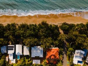 an aerial view of a beach with houses and the ocean at Villa Beach Palm Cove in Clifton Beach