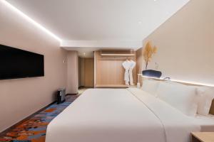 Postel nebo postele na pokoji v ubytování Sunworld Hotel Wangfujing