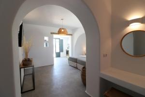a bedroom with a bed and a mirror on the wall at Archon Seaside Retreat in Plaka