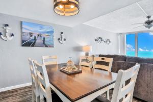 a dining room with a table and a couch at Top Floor at the Shores in Daytona Beach Shores