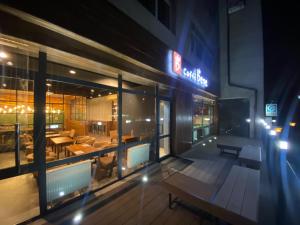 a restaurant with tables and chairs outside of a building at Tanan Center Serviced Apartments in Ulaanbaatar