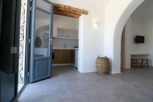 a hallway with a door leading to a kitchen at Archon Seaside Retreat in Plaka