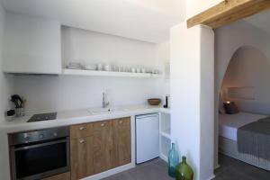 a kitchen with a sink and a bed in a room at Archon Seaside Retreat in Plaka