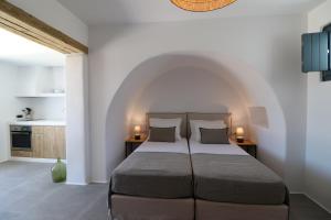 a bedroom with a large bed with two pillows at Archon Seaside Retreat in Plaka