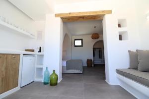 a kitchen and living room with a couch and a table at Archon Seaside Retreat in Plaka
