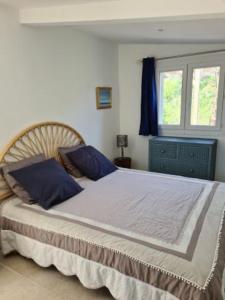 Un dormitorio con una cama grande con almohadas azules. en Casa San Niolo, en Cervione