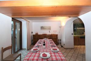 a long table with red and white plates on it at Chalet Bouquetin- Bellecôte 28 to 34 people in Champagny-en-Vanoise