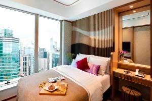 a hotel room with two beds and a window at Burlington Hotel in Hong Kong