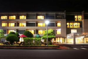 a building with a street light in front of it at Luceville in Seogwipo