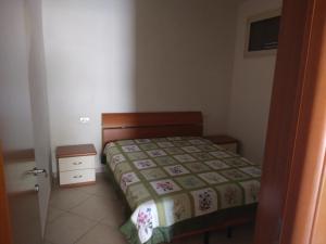 a small bedroom with a bed and a night stand at Villa Rinaldi apartment in Vieste +37 photos