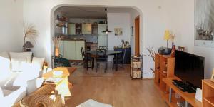 a living room with a table and a dining room at Holiday Home Marija with Pool & Garden & Amazing Sea View in Dramalj