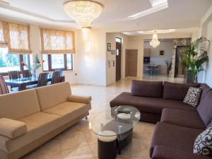 a living room with two couches and a table at Village View Afandou in Afantou