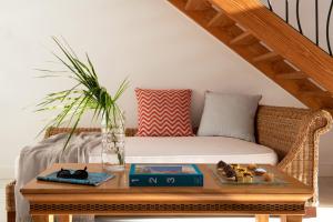 a coffee table with a couch in a room at Mitsis Selection Blue Domes in Kardamaina