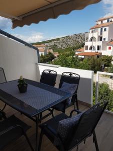 a blue table and chairs on a balcony at Apartment Magic in Stinica