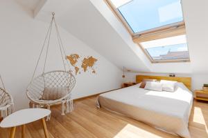 a bedroom with a bed and a swing at Roof Rooms in Ivano-Frankivsʼk