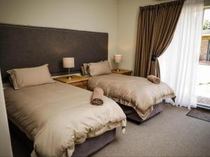 Ένα ή περισσότερα κρεβάτια σε δωμάτιο στο Goldfields Gardens Guesthouse