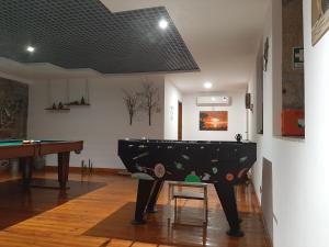 a living room with a pool table and a table at casa na aldeia - entre Fundão e Covilhã in Pêro Viseu