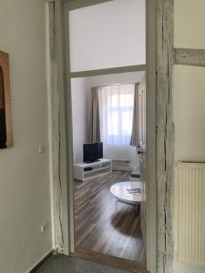 a hallway with a living room with a television at Maxima in Bamberg