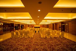 a large room with a large table and chairs at Royal Orchid Central, Shimoga in Shimoga