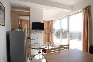 a kitchen and dining room with a table and a window at Апартамент в Комплексе Сансет Кошарица,Солнечный берег in Kosharitsa