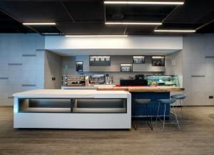 a kitchen with a counter and a bar with stools at Travelodge Myeongdong City Hall in Seoul