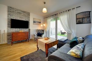 Televízia a/alebo spoločenská miestnosť v ubytovaní Trevilles apartamenty - Pod Lasem