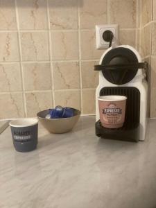 a coffee maker and two cups on a counter at Stemma Hotel in Sidari