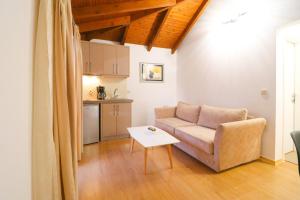a living room with a couch and a table at LIDO APARTMENTS in Himare