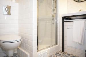 a bathroom with a toilet and a shower at Hôtel Des Arts-Bastille in Paris