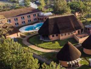 an aerial view of a house with a thatched roof at Hunters Paradise Cottages in Bungoma