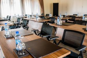 a classroom with tables and chairs with bottles on them at Hunters Paradise Cottages in Bungoma +35 photos
