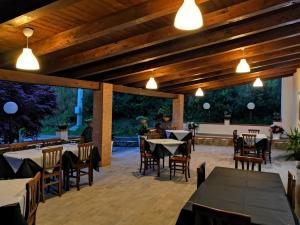 a patio with tables and chairs and lights at Il Ruscello in San Severino