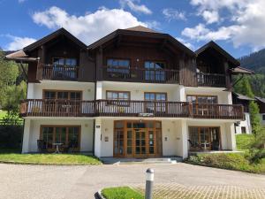 a large house with a balcony on top of it at Deluxe Panorama Apartment-Maibrunn-Alm in Bad Kleinkirchheim