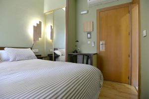 Postel nebo postele na pokoji v ubytování Hostal Concejo