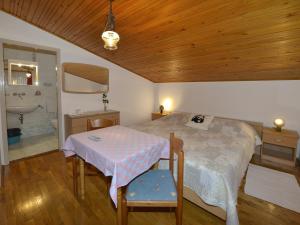 1 dormitorio con 1 cama con mesa y baño en Sobe Ana Finida, en Poreč