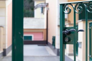 a green gate in front of a building at Edone' by PortofinoHomes in Portofino