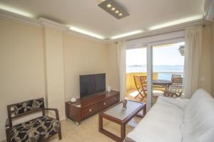 a living room with a couch and a tv at Spanish Connection - Playa Principe in La Manga del Mar Menor