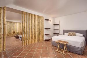 A bed or beds in a room at Casa Di Namphio Villa & Suites Anafi