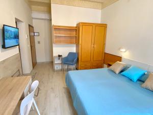 a bedroom with a blue bed and a table and chair at Residence Signa in Perugia
