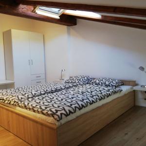 a bedroom with a large bed with a wooden frame at Apartments Gina in Piran