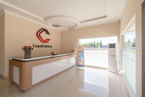 a lobby of a car dealership with a reception counter at RedDoorz @ Hotel Copacobana Bengkulu in Bengkulu