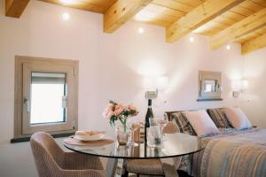 a bedroom with a bed and a table with flowers on it at Charming House in Amalfi