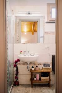 a bathroom with a sink and a mirror at Charming House in Amalfi +14 photos