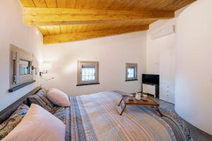 a large bedroom with a bed and a table at Charming House in Amalfi