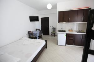 a room with a kitchen and a living room at Vila Anhel in Ksamil